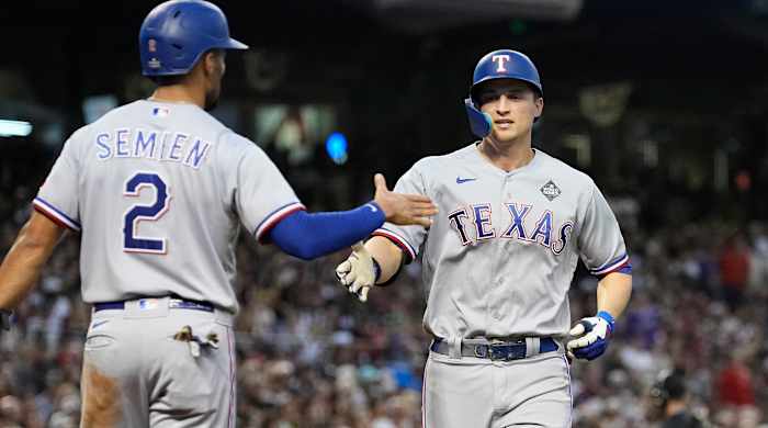 Rangers' Corey Seager, right, celebrates with Marcus Semien after both scored on Seager's home run in Game 4 of the 2023 World Series